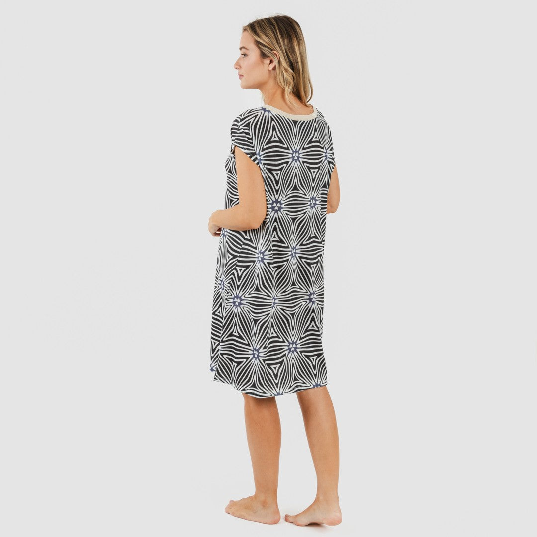 Vestido Naty de mangas curtas e modelagem fluida em tons suaves de bege e preto.